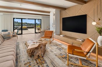 a living room with a couch and chairs and a television